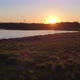 Aerial View Shot with a Drone of a Lake Landscape at Sunset Sun and Sky Reflected in the Water - VideoHive Item for Sale