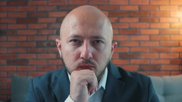 Close-up portrait of young man in the suit looking in the camera and shaking head, gesturing no