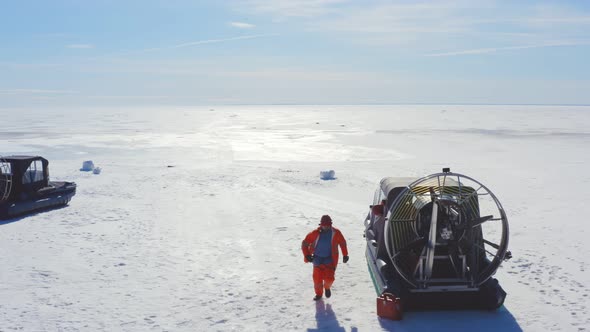 Rescuers Jumping Off Air Boat and Running to Save Drowning in Arctic