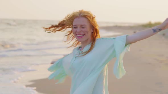 The Young Beautiful Woman Rotate on Sand Sea Shore in Slow Motion