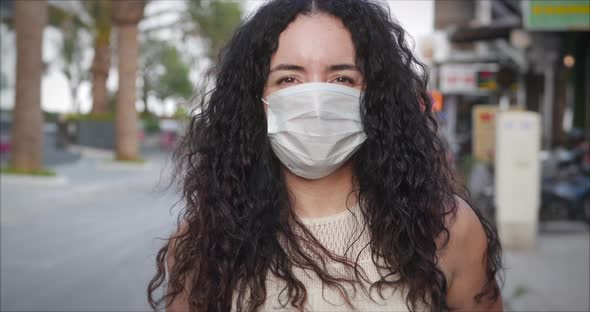 Portrait of a Young Student Mixed Race Woman Wearing Protective Ask on Street. Concept of Health 