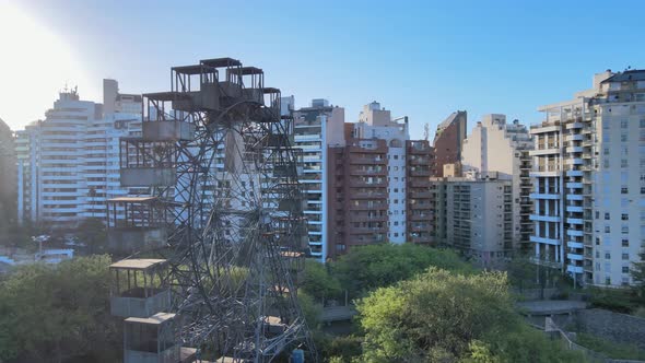 Abandoned Rueda Eiffel ferris wheel in Argentina, residential buildings in background. Aerial point