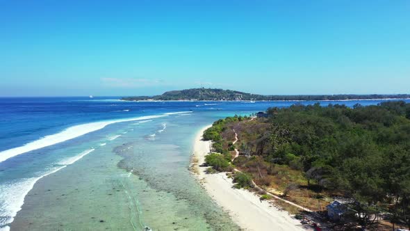 Aerial drone panorama of idyllic lagoon beach wildlife by blue water with clean sandy background of 