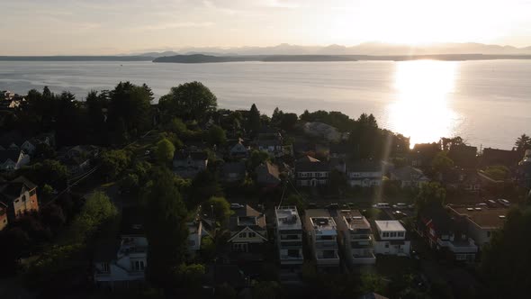 West Seattle Aerial View Of Residential Neighborhood Houses With Ocean And Mountains Background