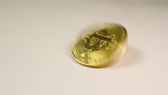 Bitcoin cryptocurrency gold coin - BTC - Bit Coin spins on a white background