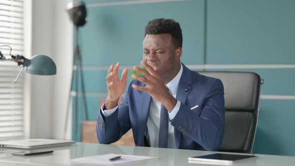 African Man Feeling Angry While Sitting in Office