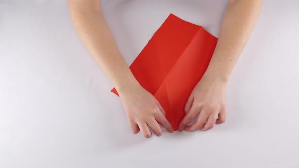 Girl Making Origami. Red Envelope. Time Lapse