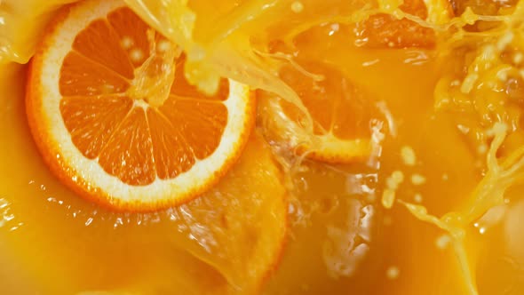 Super Slow Motion Shot of Orange Slices Splashing To Orange Juice at 1000Fps.