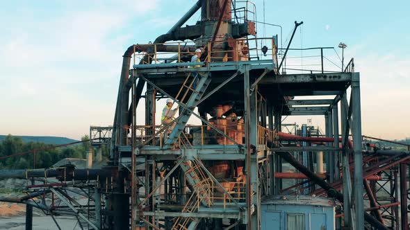 Engineers Are Walking Upstairs a Metal Construction in Port