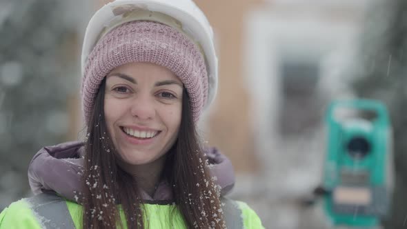 Closeup Face of Charming Positive Female Topographer Posing Outdoors in Snowfall