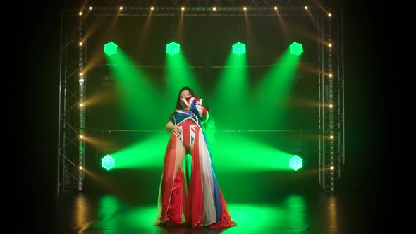 Chic Girl Dancing in a Sexy Suit in the Color of the English Flag and Rhinestones, Attractive