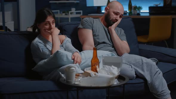 Depressed Frustrated Young Couple Sitting in Couch Suffering From Insomnia