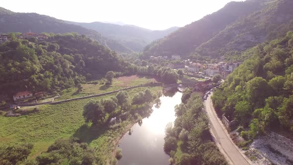 Drone View of the Crnojevica River Stone Bridge and Houses on the Shore