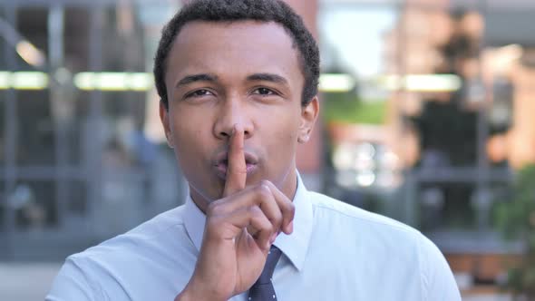 Silence Please, Finger on Lips by African Businessman
