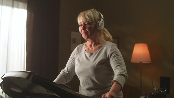 Aged Woman Running on a Treadmill