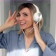 Portrait of cheerful european woman in headphones listening to music - VideoHive Item for Sale
