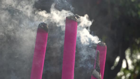 Red joss stick release smoke during burn