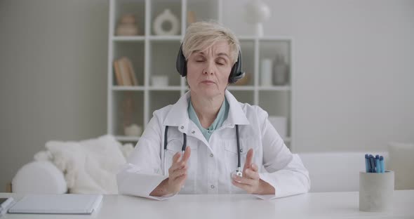 Middle-aged Woman Is Speaking Lecture By Medicine, Doctor Is Explaining, Looking at Camera, Webinar