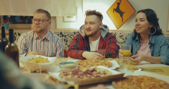 Meeting Friends Indoors Men and Women Eating Pizza