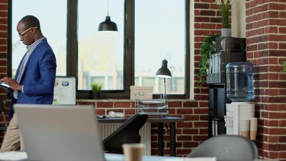 Company Employee Pacing Around in Startup Office