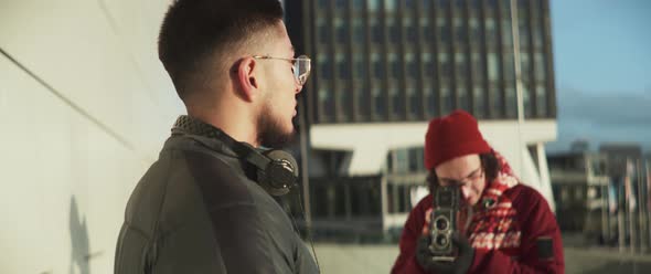 Two men on a photoshoot using a vintage camera