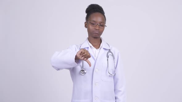 Young Sad African Woman Doctor Giving Thumbs Down