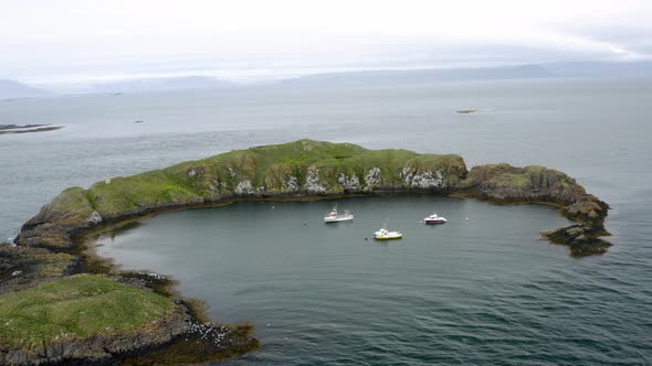 Sailing Boats Dock On Calm Water Surrounded By Rugged Mountains Near Flatey Island In Breidafjordur