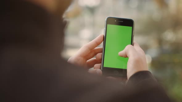 Man Scrolling Smartphone Green Screen, Guy Surfing Internet Mock Up Cellphone