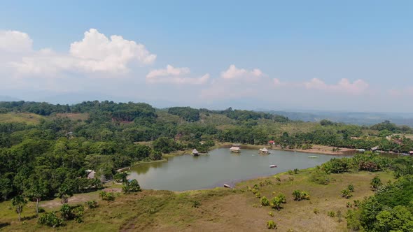 Fascinating 4k aerial panoramic view over the lush green tropical rain forest and the Laguna de los