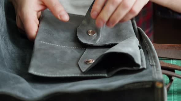 Man Tailor Repairing Bag Made of Artificial Leather Closeup