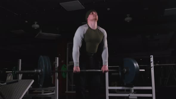 Man Doing Deadlift with Heavy Barbell