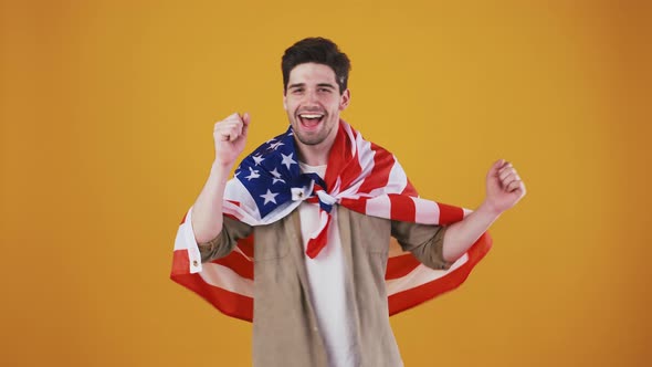 Young Male Wrapped in Flag of USA is Smiling Dancing Winking and Kissing Cloth of Stripes and Stars