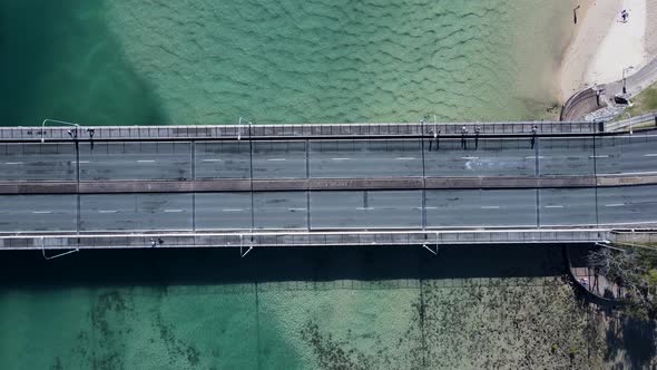 Panning view of a bridge spanning Tallebudgera Creek allowing vehicles and pedestrians to cross the