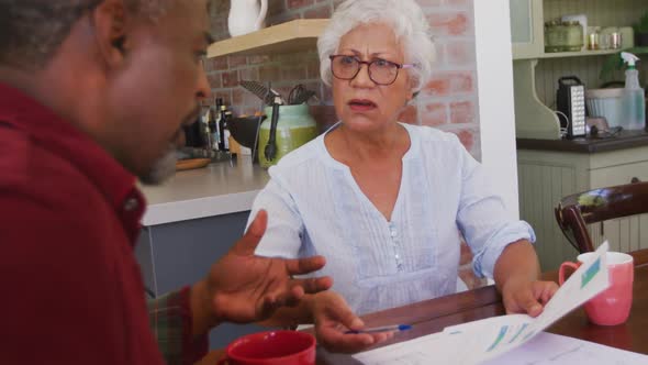 Senior African American husband and mixed race wife working together at home