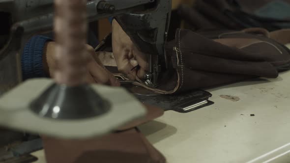 Employee Sewing Leather Bag on Sewing Machine