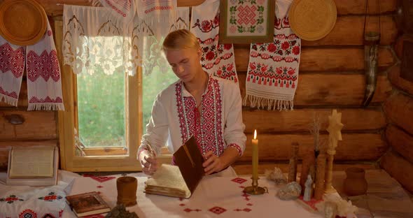 Traditions and Customs of the RussianUkrainian Peoples a Man in a National Costume Sits at a Table