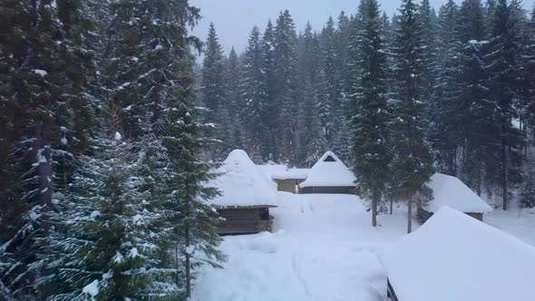 Flying Over Wooden Houses in Winter