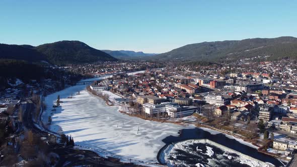 Numedalslagen river during sunny winter morning - Backward moving panoramic aerial view from Kongsbe