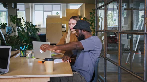 Young Diverse Colleagues Working Together on Laptop Making Reminders on Sticker Slow Motion