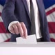 Voting. Man Putting a Ballot into a Voting Box with British Flag on Background. - VideoHive Item for Sale