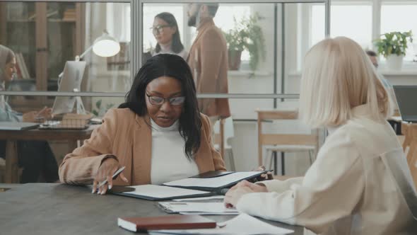 Happy African-American Woman Singing Document in Meeting