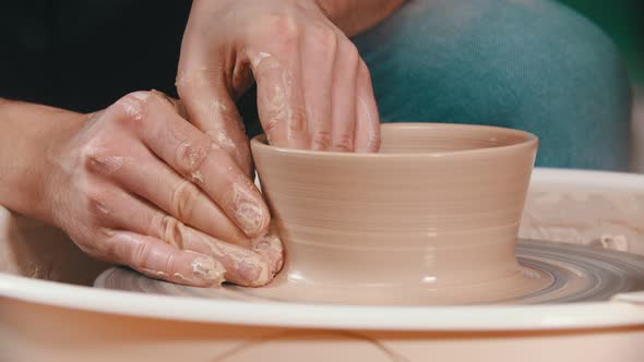 Pottery - the Master Is Raising the Walls of the Clay Bowl with His Hands on the Potter's Wheel in