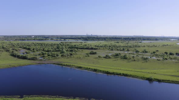 Scenic Aerial View of a River and Green Fields in a Countryside
