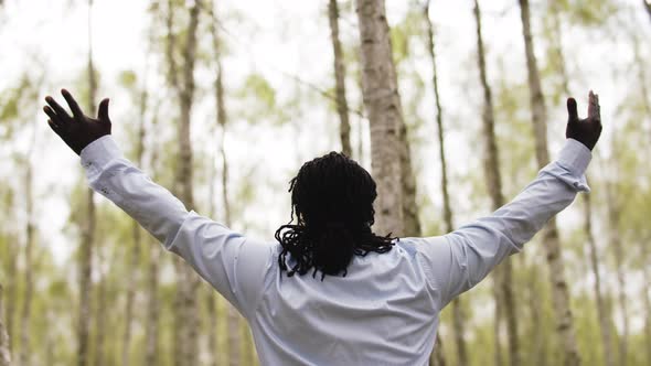 Black Lives Metters. African Businessman with Outstretche Hands Praying in the Park