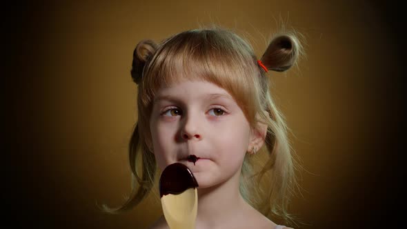 Happy Little Kid Girl Licking Melted Chocolate Child Eating Enjoying Unhealthy Sweet Food Indoors