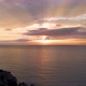Aerial shot zoom in movement of a sunrise with some clouds and sun rays in the Mediterranean sea. - VideoHive Item for Sale