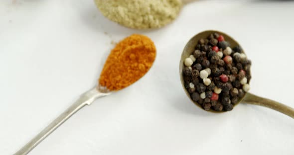 Various spices in spoon on white background 4k