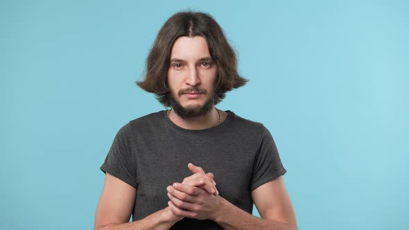 Portrait of Concentrated Hairy Guy in Casual Gray Tshirt with Brooding Look Thinking Hard or