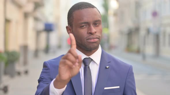 Outdoor African Businessman Showing No Sign By Finger Denial