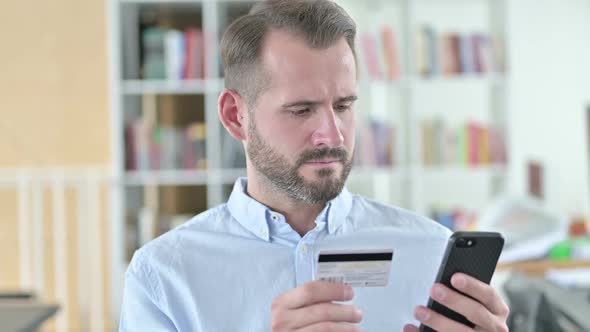 Portrait of Online Payment Failure on Smartphone By Man